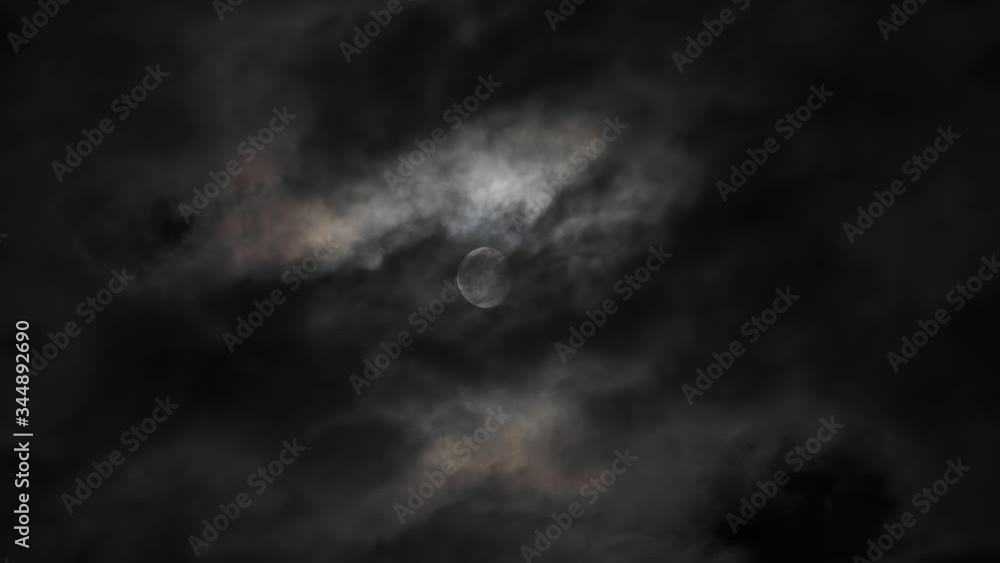 Wall mural moon behind dark clouds moving at night in real time