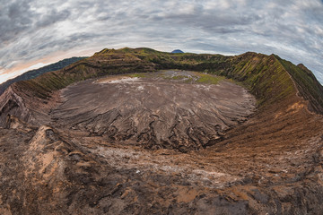 Sunrise View of the active volcano Bromo and Semeru in West Java in Indonesia. Volcano eruption in a national park Bromo Tengger Semeru. puffs of smoke and clouds. 