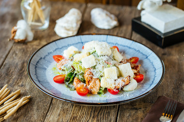 Gourmet appetizing caesar salad with fried chicken
