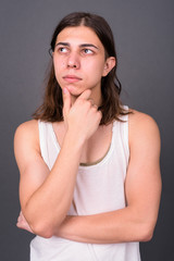 Young handsome androgynous man with long hair