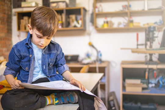 Cute Boy Reading Instructions How To Make Birdhouse