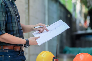 The engineer is giving advice and consulting with the designer to find out the construction site where the engineer will have to construct the project. Consultation between engineers and designers