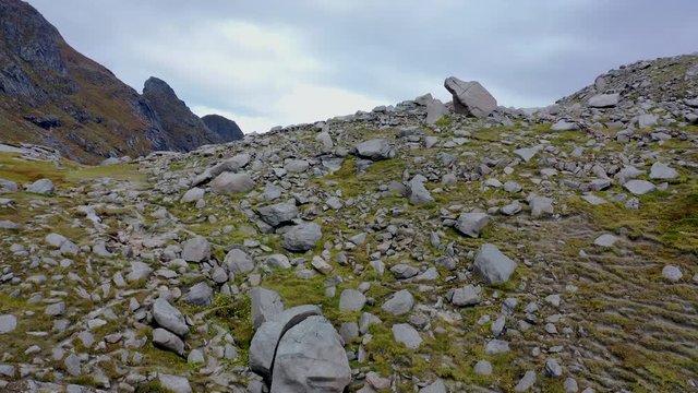 Droneflight over an idyllic Fjord and a small norwegian Village in Lofoten Islands in Norway during autumn time ("Bunes Beach" near Reine, Lofoten)