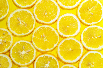 Lemon cut in half background. A slices of fresh yellow lemon pattern. Lemon pieces in different sizes.