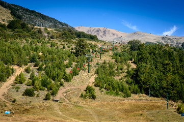 Aerosilla in the mountain of Bariloche. Cerro Catedral without snow in summer. Empty spars. Chairlift machine