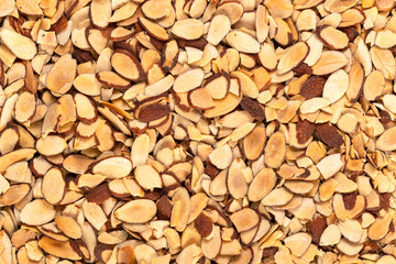 Full frame of a roasted pile of sliced almonds, texture, ingredients, background.