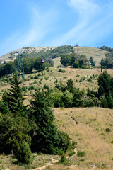 Fototapeta premium Aerosilla in the mountain of Bariloche. Cerro Catedral without snow in summer. Empty spars. Chairlift machine