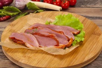 Sliced smoked duck breast served salad