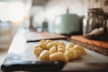 Chopped and peeled potatoes in kitchen 