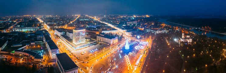 Fototapeta premium Gomel, Belarus. Main Christmas Tree And Festive Illumination On Lenin Square In Homel. New Year In Belarus. Aerial Night View. Panorama