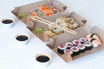 Japanese sushi food delivery concept. Eco paper packaging or boxes for take away. Healthy food background. Takeout meal