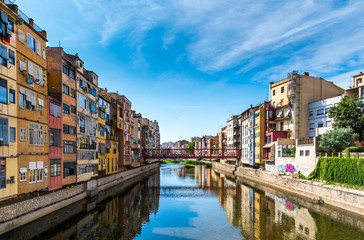 Fototapeta na wymiar Colorful houses and Eiffel bridge over Onya river in Girona, Spain
