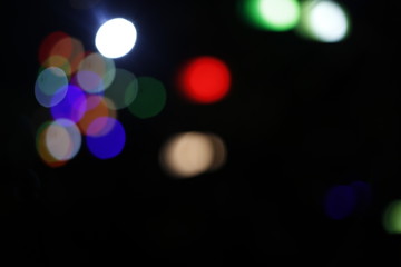 Colorful light bokeh moving on black background
