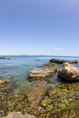 Fototapeta na wymiar Panorama of the wild nature, blue crystal water of Mediterranean sea and rocky coastline at sunset in province Syracuse in Sicily