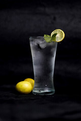 Refreshing homemade cocktail lemon juice,syrup and mint with black backgroung 