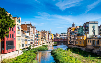 Naklejka na ściany i meble Colorful houses and Eiffel bridge over Onya river in Girona, Spain