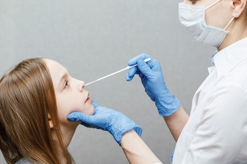 Pediatrician taking nasal mucus test sample