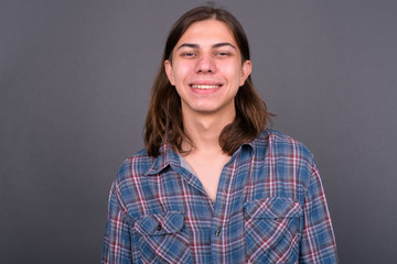 Young handsome hipster man with long hair