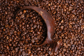 Roasted coffee beans in wooden bowl . Selective focus