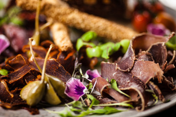 Meat platter for two: Dry-aged beef brisket, dry-aged duck fillet, beef liver pate, dry-aged lamb striploin, cranberry jam and grissini. Delicious healthy Italian traditional antipasti snacks food