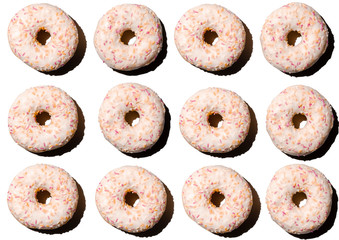 doughnuts in pink glaze on a white isolated background, pattern top view