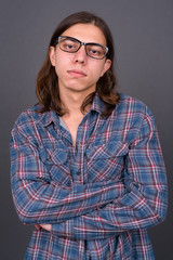 Young handsome hipster man with long hair