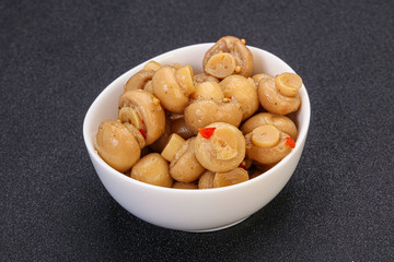 Pickled champignons in the bowl