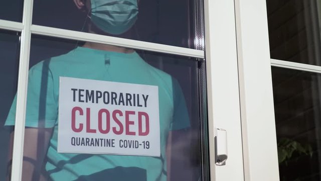 Owner changes the label from OPEN to TEMPORARILY CLOSED during the coronavirus pandemic. Private business closes from the quarantine COVID-19 pandemic. Small business incurs losses during coronavirus.
