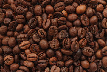 Dark brown Roasted coffee beans background, top view