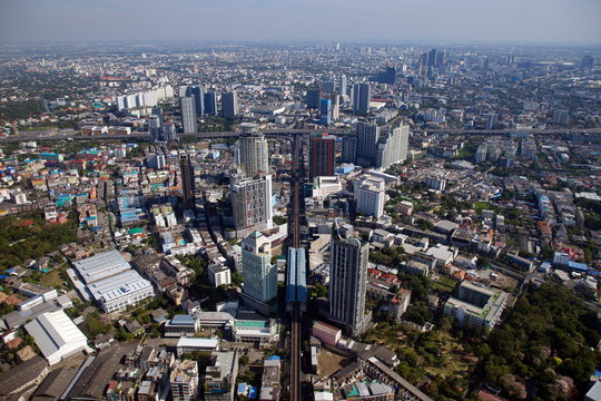 BANGKOK, THAILAND - JAN 1, 2019: Aerial photograph of Bangkok above the Skytrain station Go straight until there is a cross-section highway There are many buildings and houses. With a weird horizon.