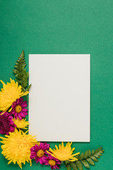 White invitation with yellow and purple flowers mockup