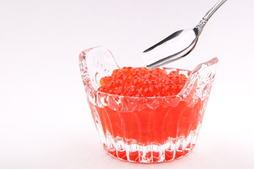  red caviar and a spoon on a white background