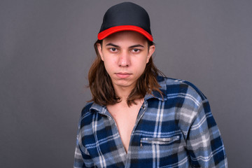 Young handsome hipster man with long hair