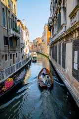 Fototapeta na wymiar canal in venice italy with some boats and a gondola