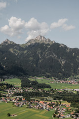 Fototapeta na wymiar Germany. View of the alps and alpine village. Mountains, houses, sunny weather.