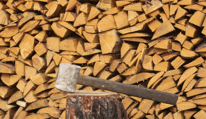 ax on the background of chopped firewood. chopped firewood. beautiful ax

