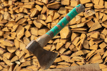 ax on the background of chopped firewood. chopped firewood. beautiful ax

