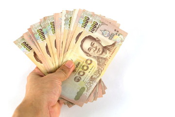 Many 1,000 baht banknotes in the hand On a white background