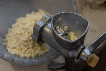 Manual meat grinder grinds cheese