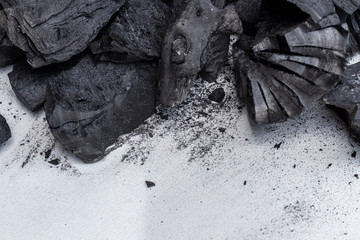 A pile of charcoal on white background.