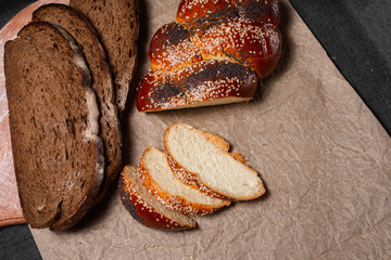 Baking, rolls, bread and milk on a dark background