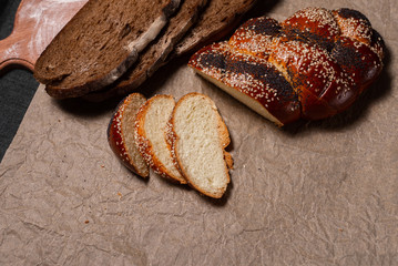 Baking, rolls, bread and milk on a dark background