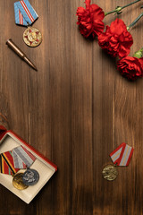 Medals and flowers on wooden table for day of glory, 9 may