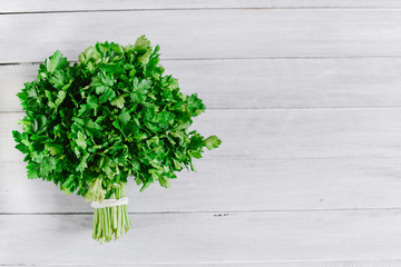 Bunch of fresh parsley on the white background. Top view. Copy space. Flatlay