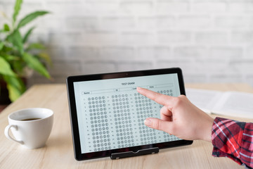 Online exam. girl student testing exercise. Examination test on the tablet for school, university. multiple choice answer sheet. Home school, online study. Pandemic, online study