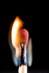 Burning match, on a black background. Macro shot,.