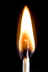 Burning match, on a black background. Macro shot,.