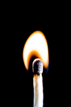 Burning match, on a black background. Macro shot,.