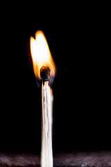 Burning match, on a black background. macro shot.