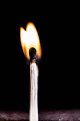 Burning match, on a black background. macro shot.